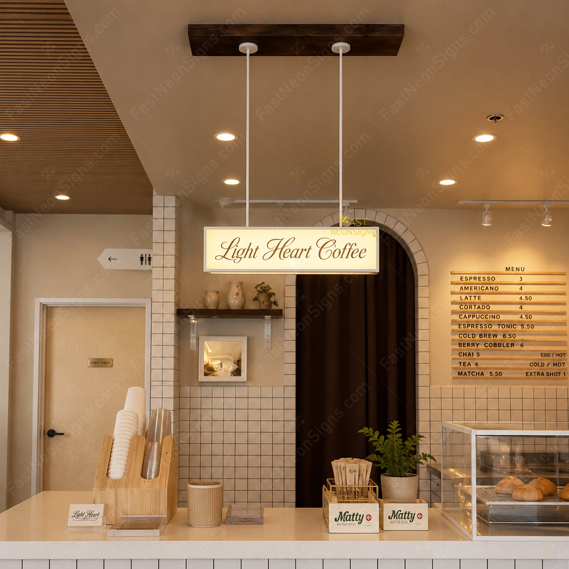 Custom hanging acrylic light box with metal frame installed above a bubble tea shop pickup counter with cold white LED lighting.